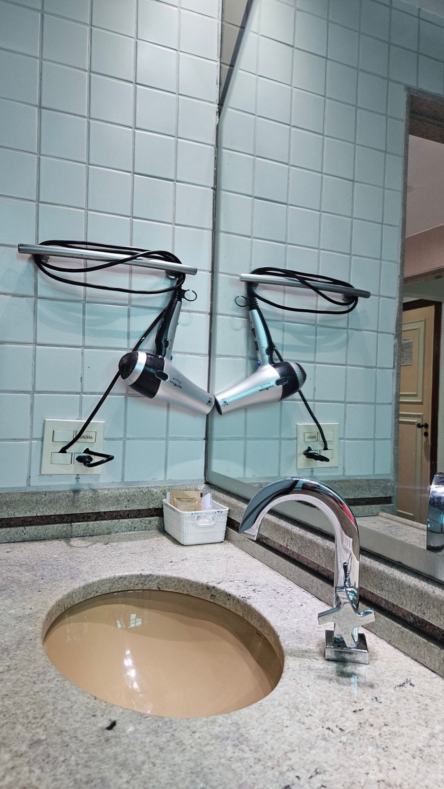 Bancada do banheiro com secador e espelho